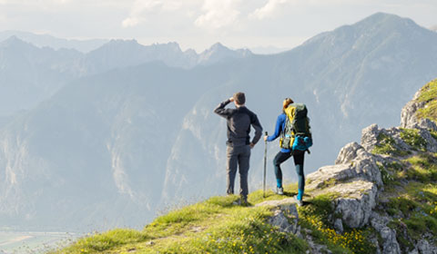 Photograph of hikers stopping at summit to take in the view