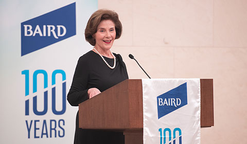 Laura Bush stands speaks at podium.