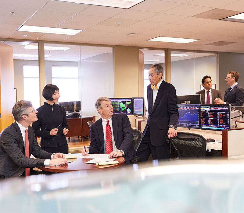 Photo of Baird associates in a meeting with client