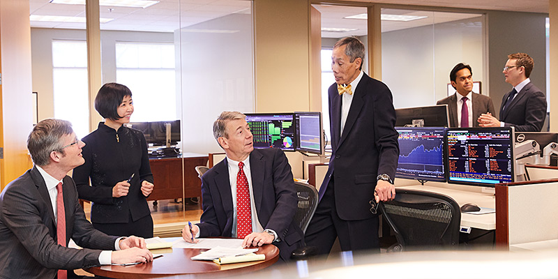 Photo of Baird Asset Management Associates in a meeting with client