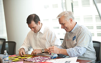 Two men working on a community service project.