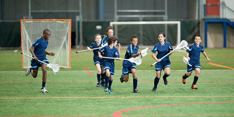Young kids playing lacrosse.
