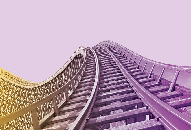 Wooden roller coaster track with blue sky in the background