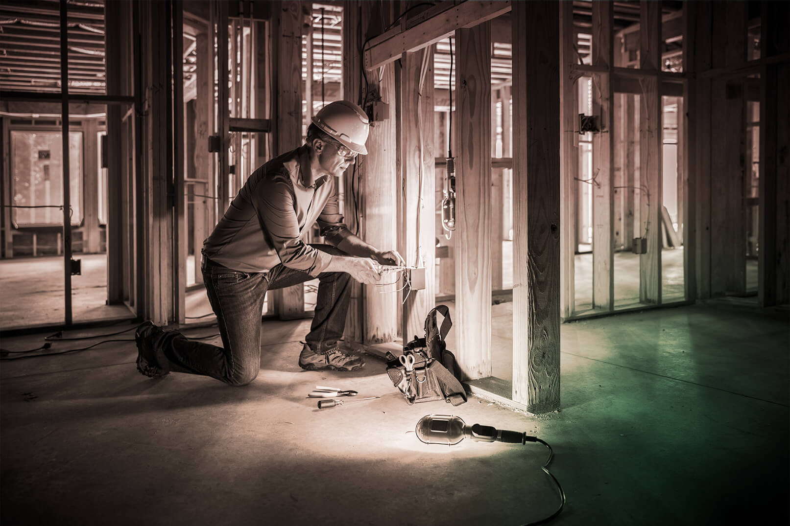 Photograph of construction working doing electrical work.