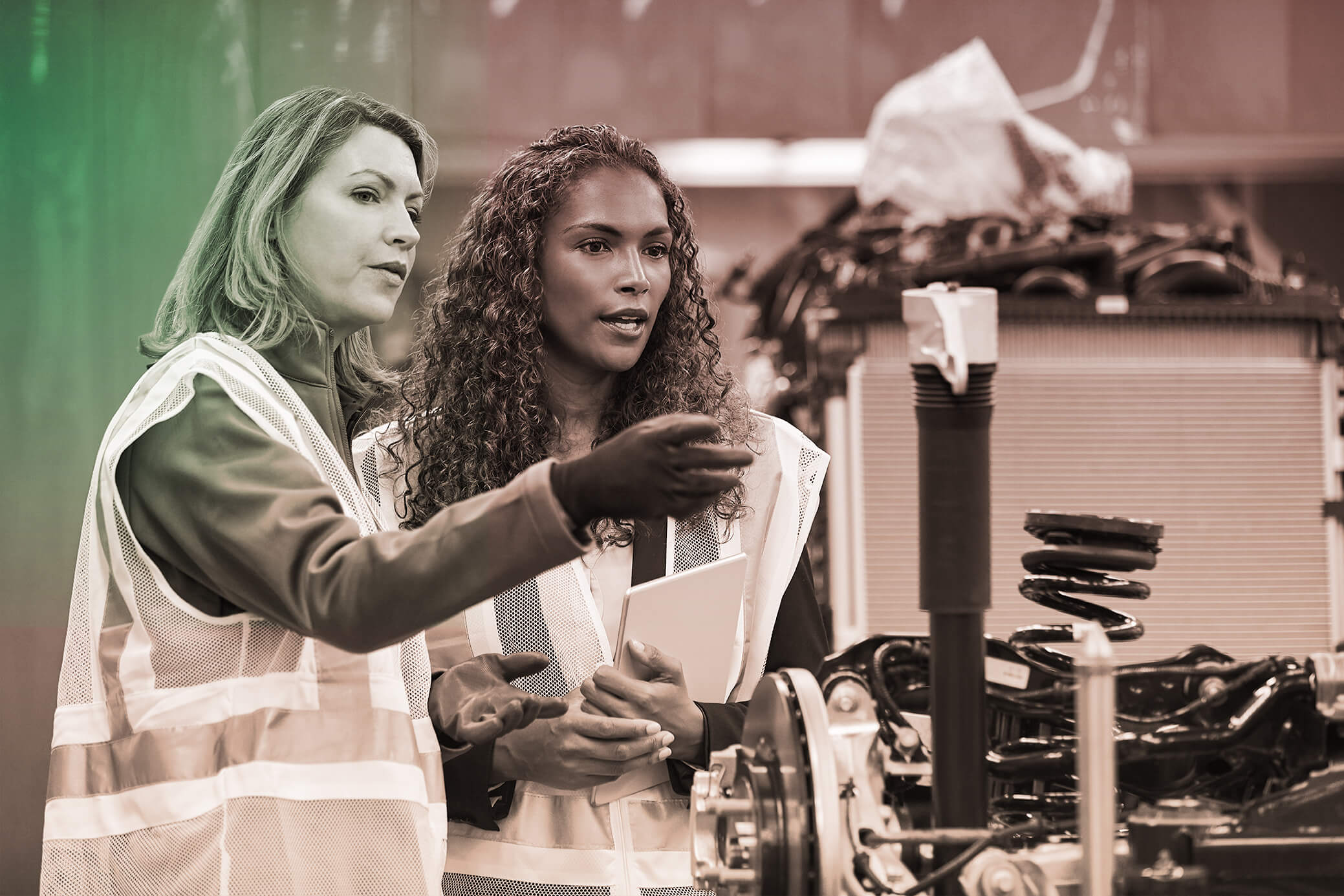 Photograph of two female workers in an industrial plant.