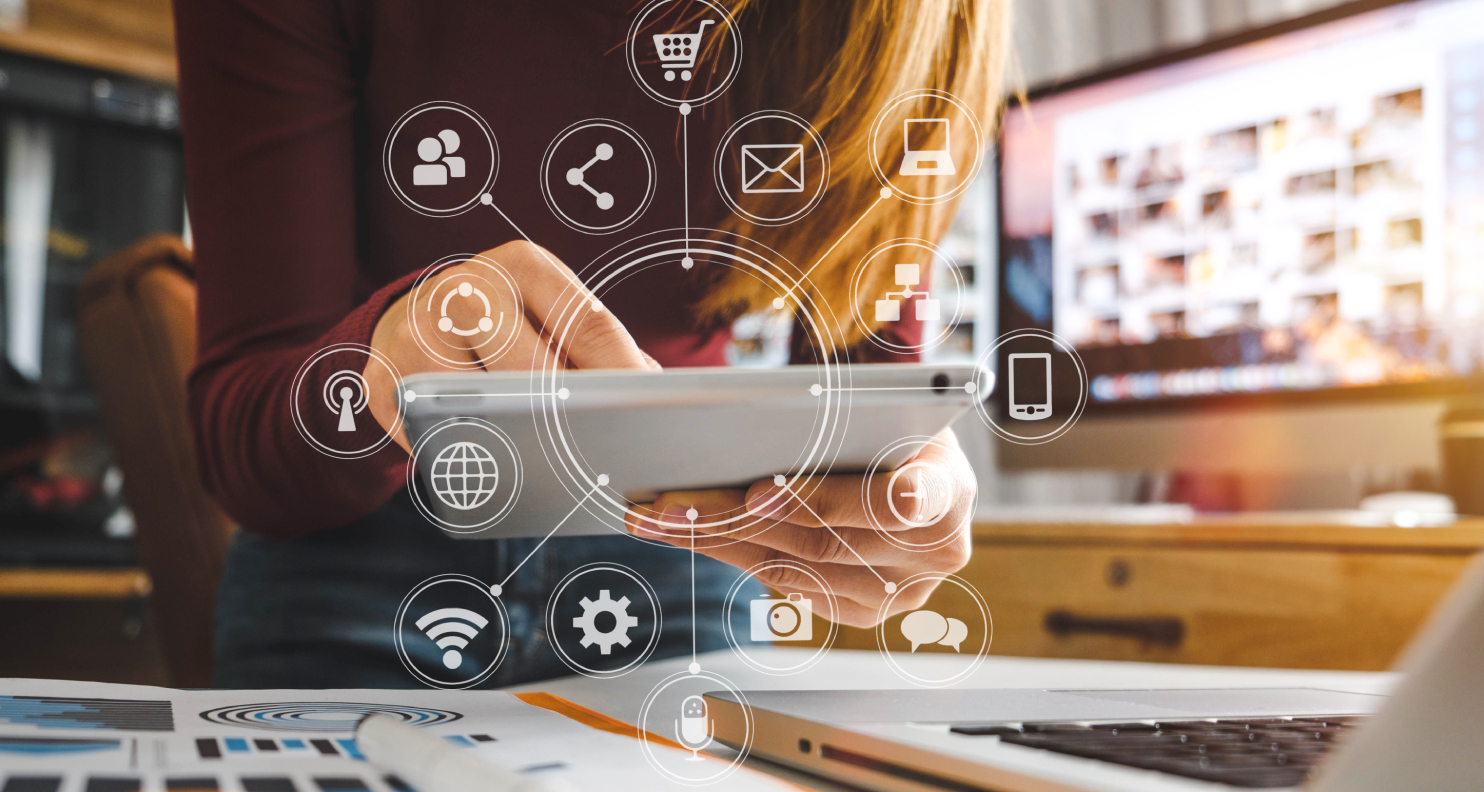 Woman holding a tablet and tech icons floating in the air.