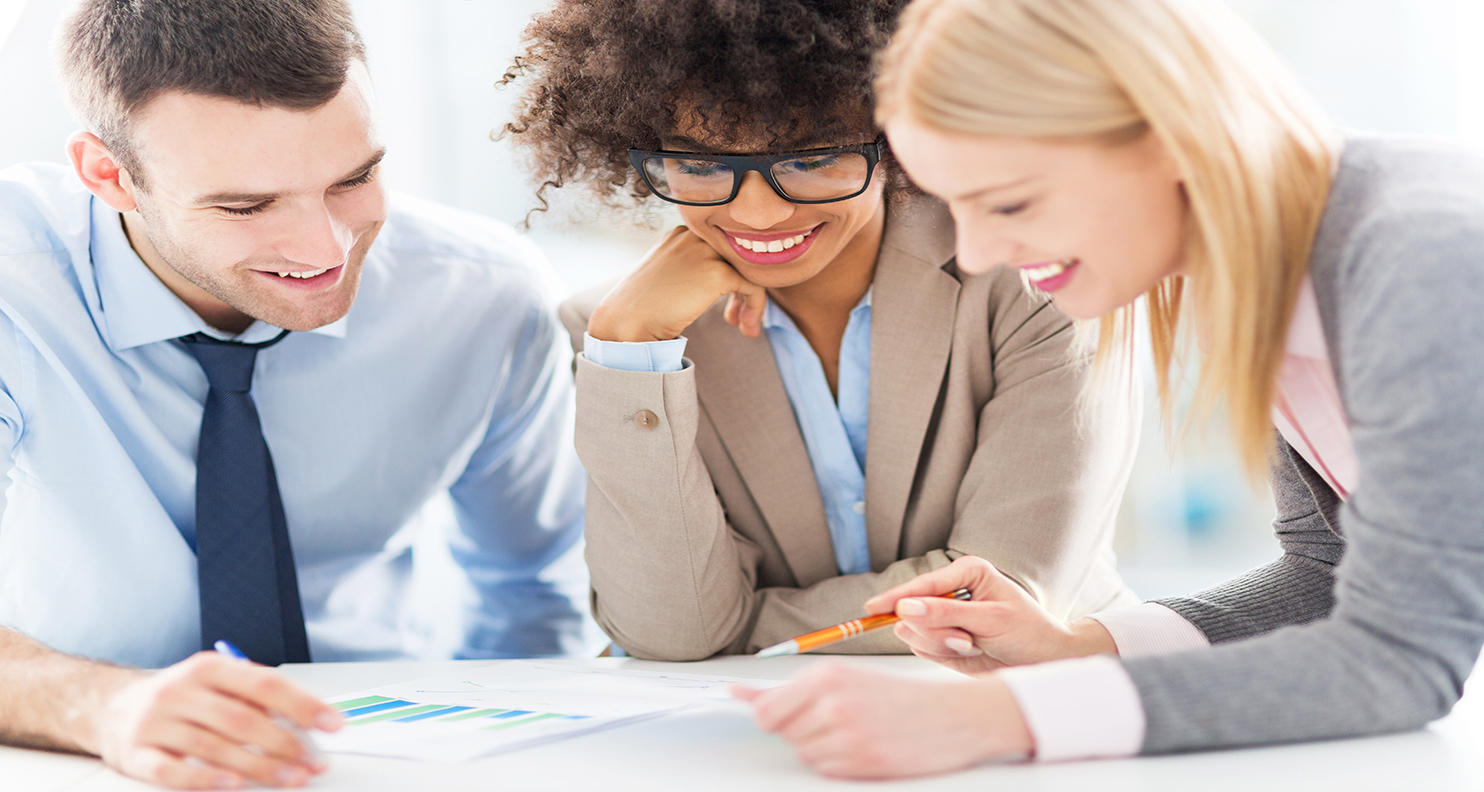 Two women and a man looking at paperwork
